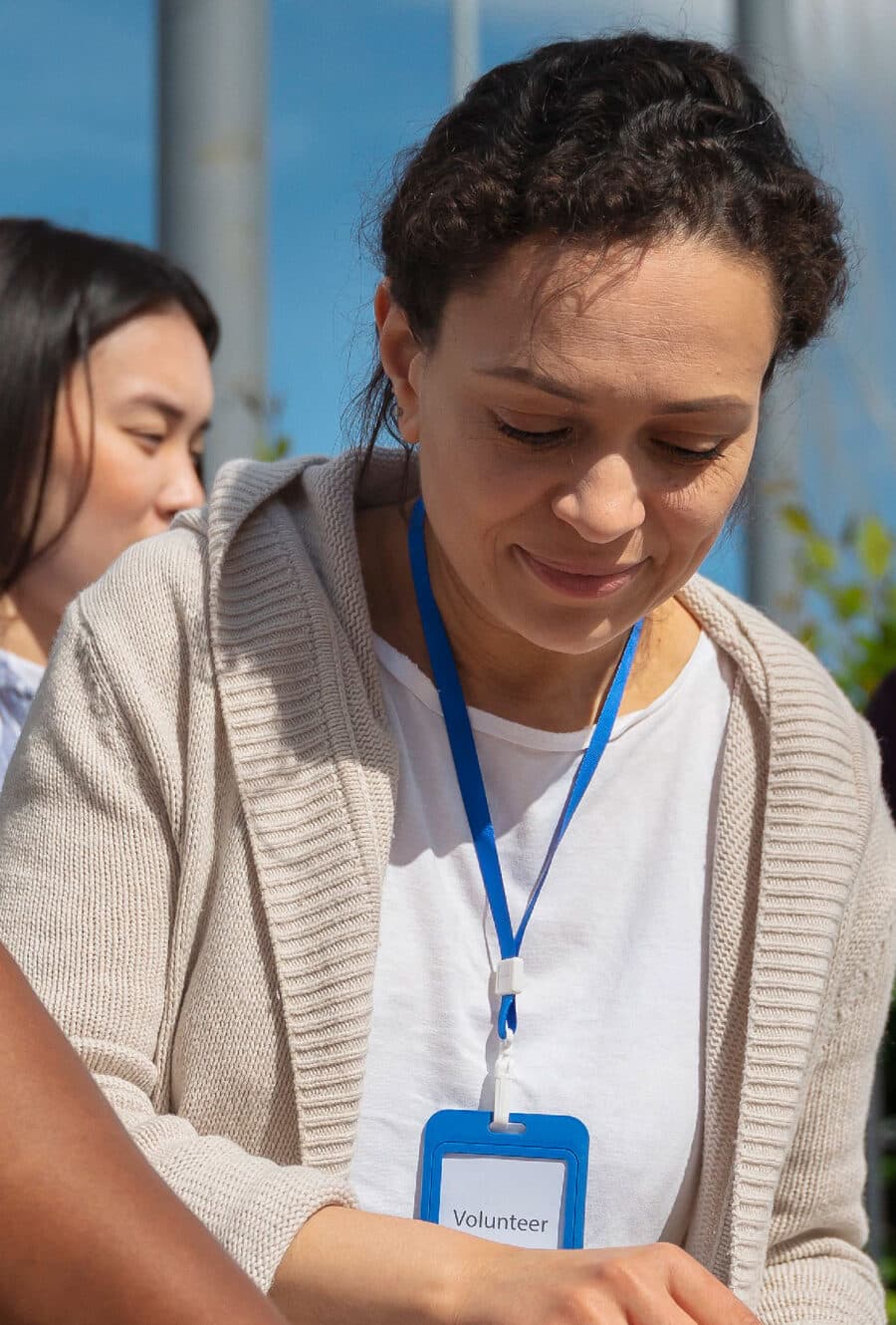 A volunteer smiling while packing donations at a community drive